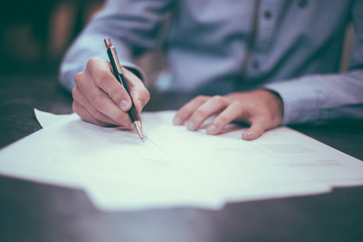 Business owner reviewing government funding paperwork with advisor